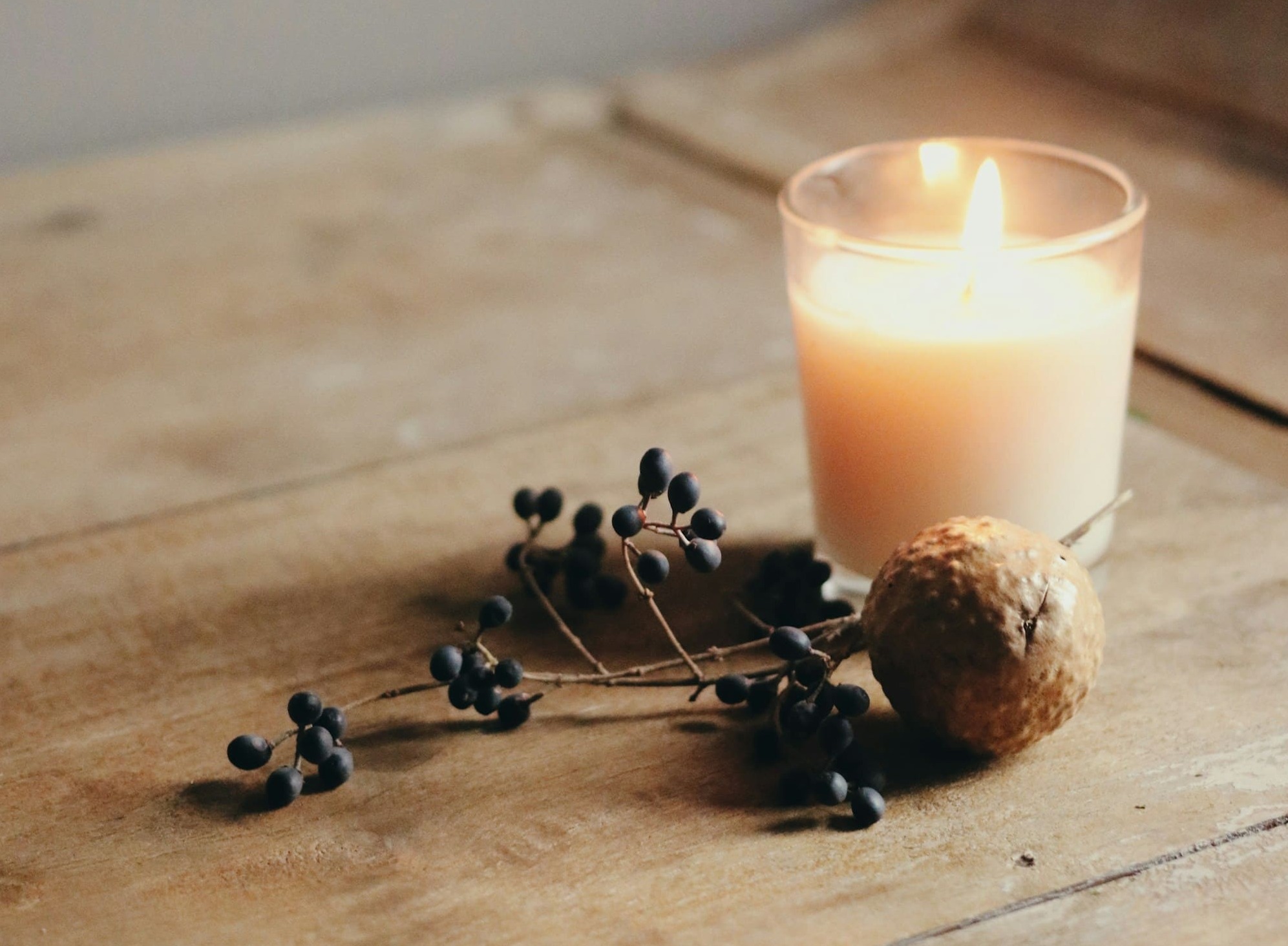Candle glowing in a quiet warm interior